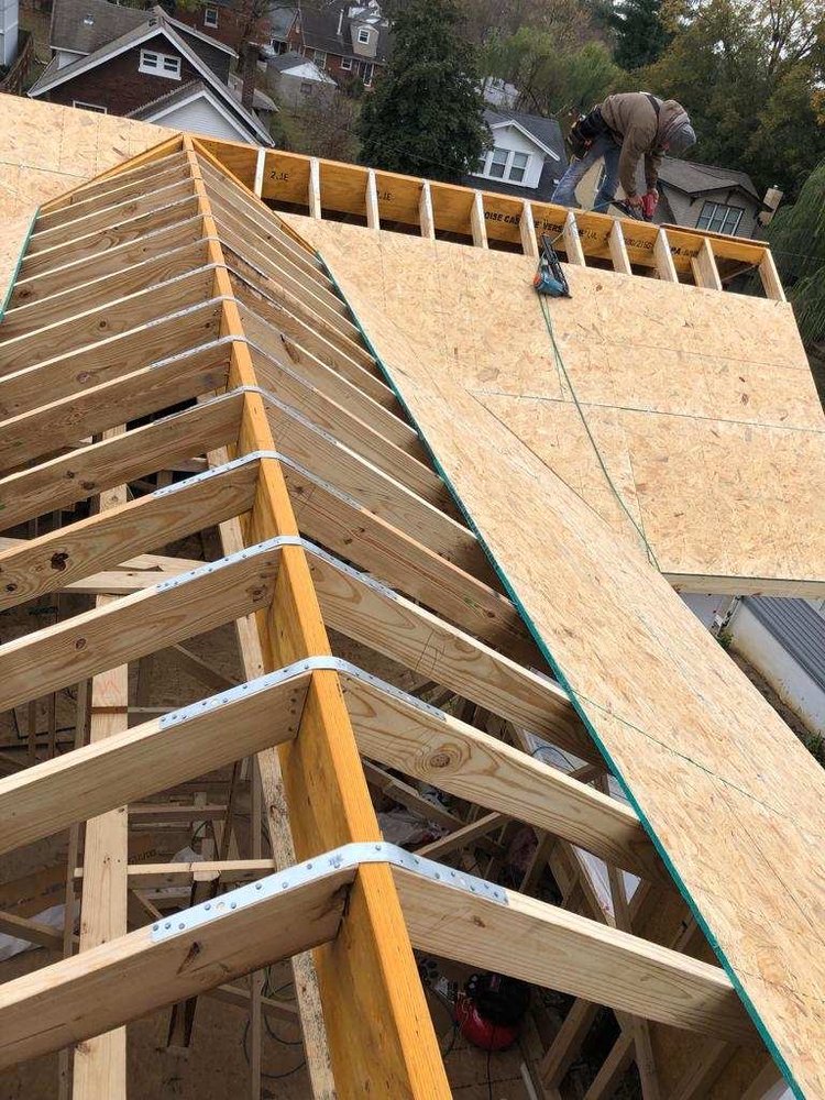 Roof framing and OSB sheathing during a new roof installation